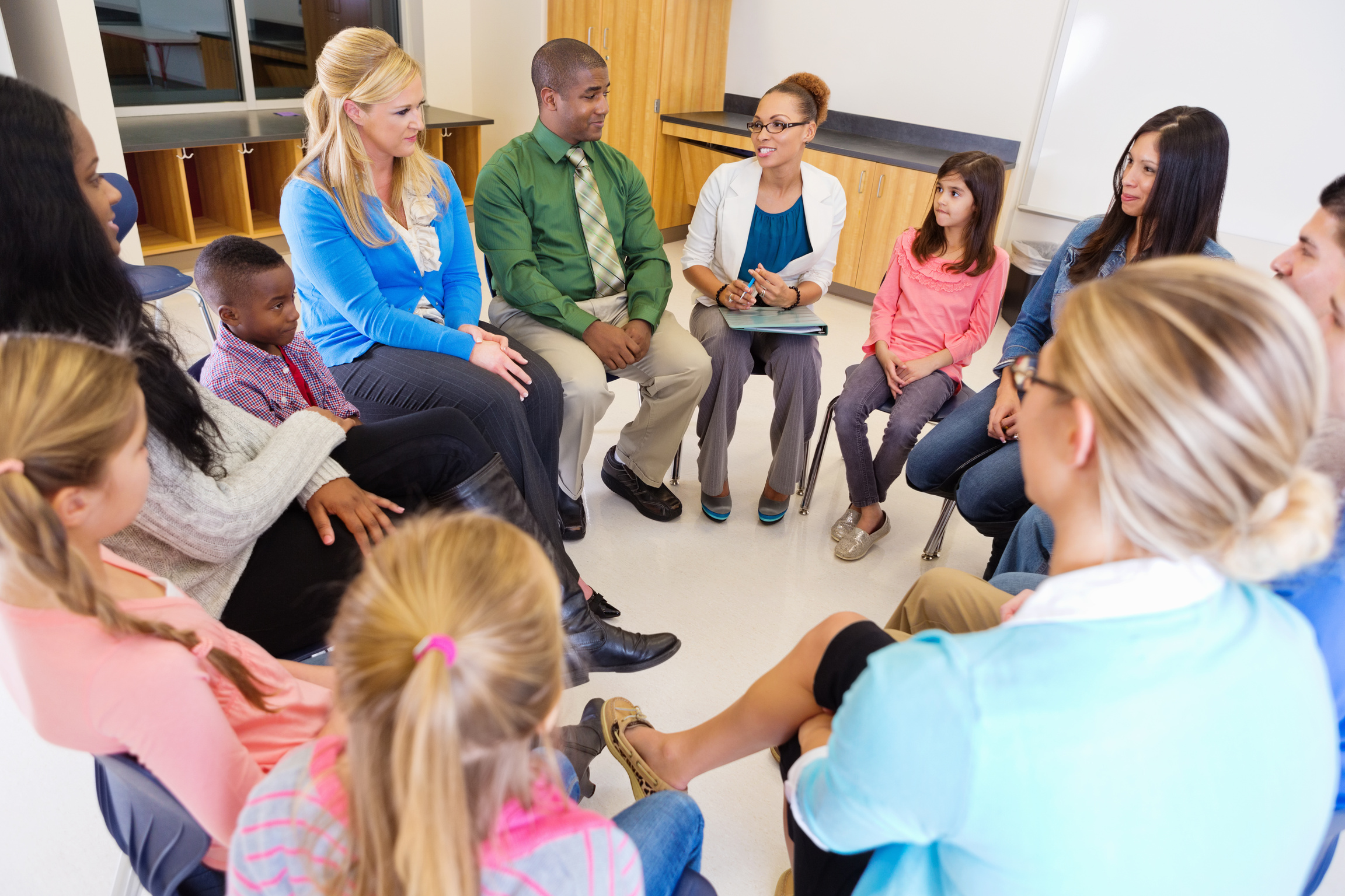 Elementary school discussion meeting with teachers parents and students